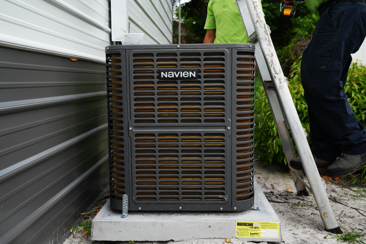 Navien NAZ series high-efficiency heat pump outdoor unit installed outside a workshop in Florida