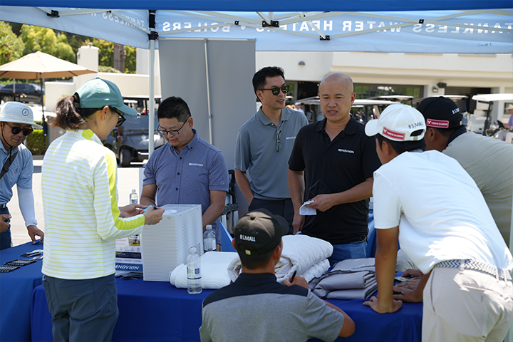 Tournament participants and spectators learning about Navien products at Marbella Country Club