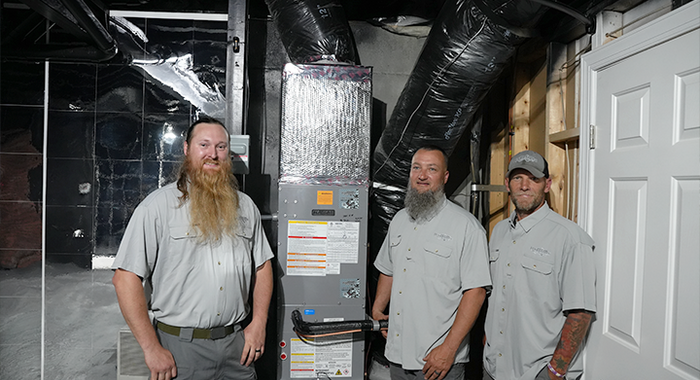 Benchmark Service Company contractors installing a Navien NAZ heat pump and NAS air handler system in North Carolina