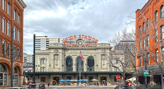 Exterior architecture of the historic Crawford Hotel in downtown Denver, showcasing its classic brick facade and street corner view