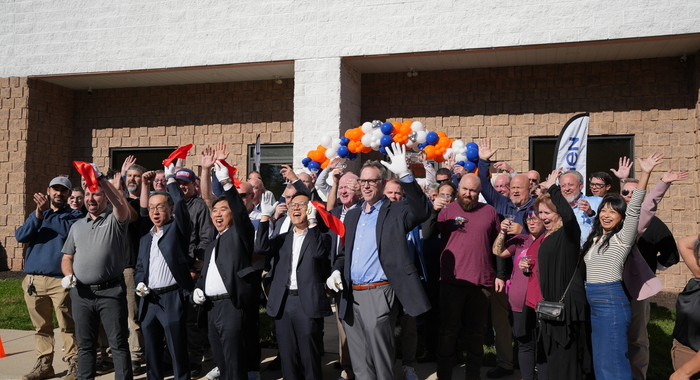 Navien employees, partners, and guests gathered outside the New Jersey Training Academy during the grand reopening celebration and ribbon-cutting event