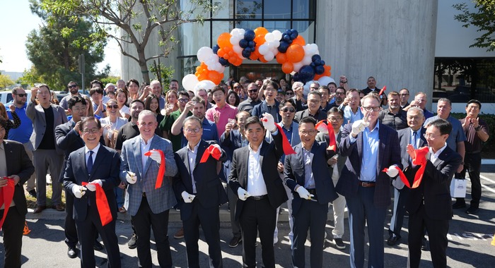 Navien executives, employees, and guests gather outside the Irvine Innovation Center & Training Academy for a ceremonial ribbon-cutting celebrating the facility's grand opening